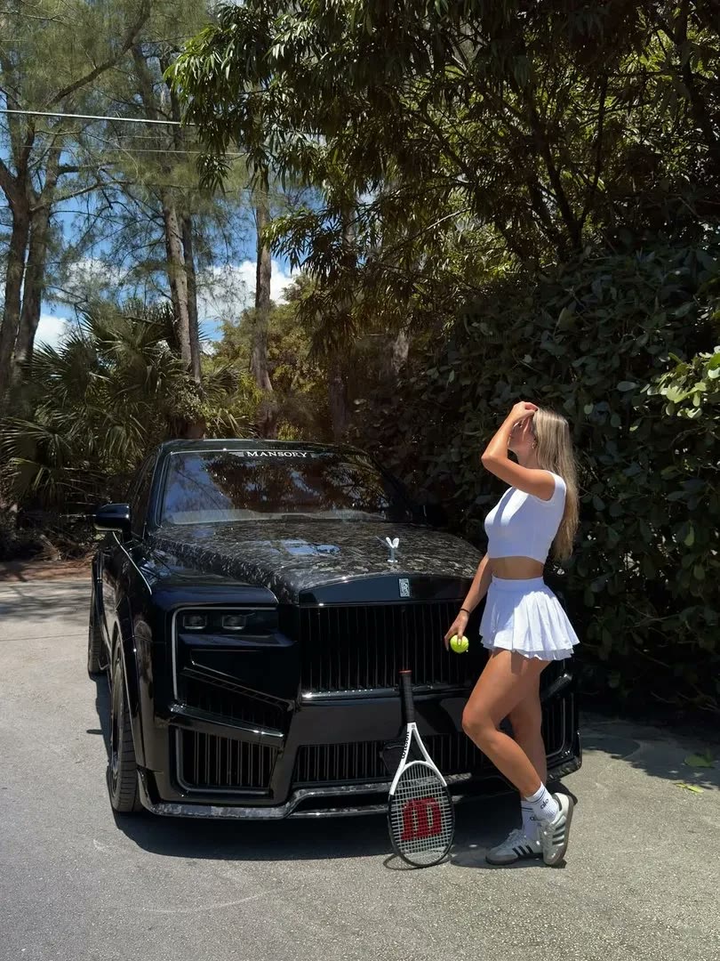 Claudia beside a black Rolls-Royce
